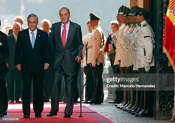 King Juan Carlos of Spain and the President of Chile Sebastián Piñera walk into the Presidential Palace La Moneda on June 5, 2012 in Santiago, Chile.