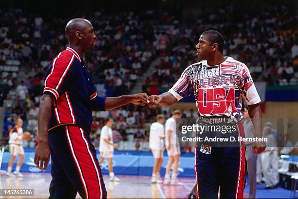 Magic Johnson and Michael Jordan of the United States high five each other against Lithuania during the 1992 Olympics on August 6, 1992 at the Palau...