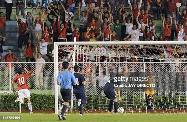 Indonesia forward Irfam Bachdim celebrates after a goal during a friendly football match at the Rizal memorial stadium in Manila on June 5, 2012. The...