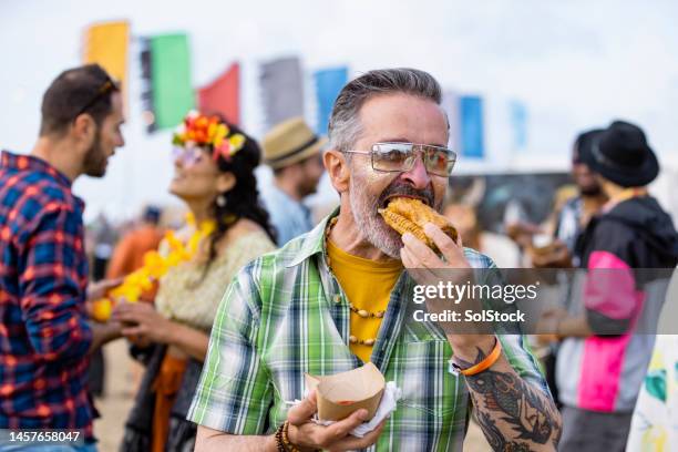 enjoying food at a festival - sausage roll stock pictures, royalty-free photos & images