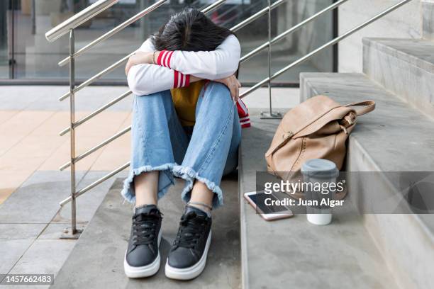 anxious teenage student worried about school bullying - bully school stock-fotos und bilder