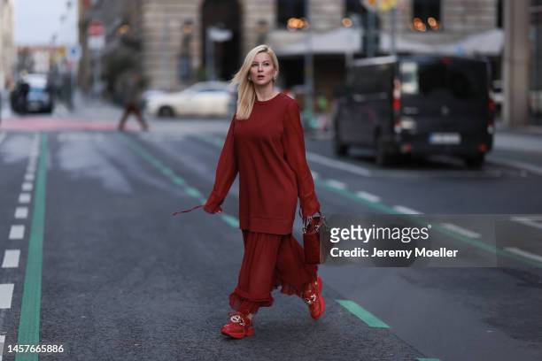Palina Kozyrava seen wearing Maison Margiela Bordeaux long dress, Lady Dior small bag, Natkina silver jewelry, Skechers matching sneaker and Maurice...