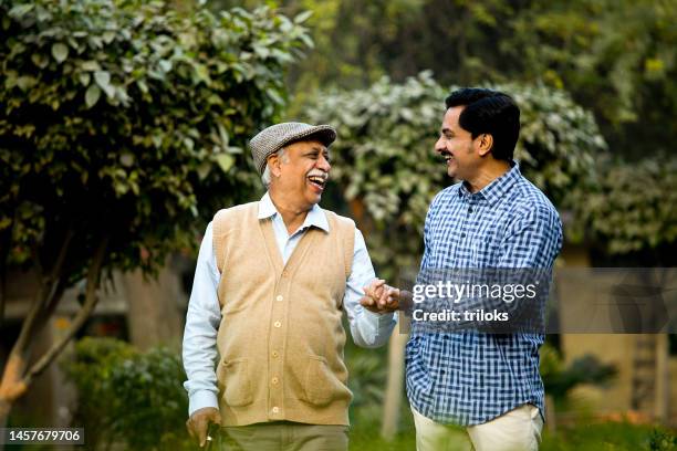 father and son having fun at park - son in law stock pictures, royalty-free photos & images