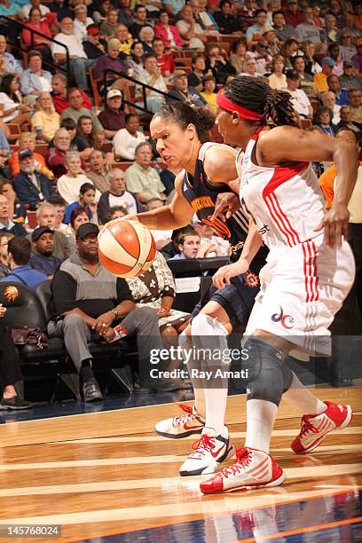 Kara Lawson of the Connecticut Sun moves the ball against Dominique Canty of the Washington Mystics on June 3, 2012 at the Mohegan Sun Arena in...