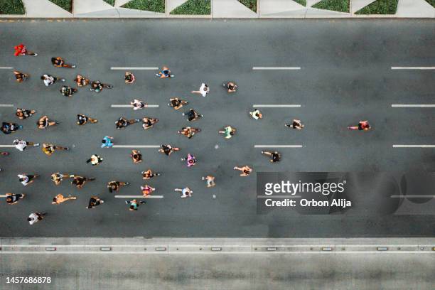 one person leading marathon - crowd of people walking stock pictures, royalty-free photos & images