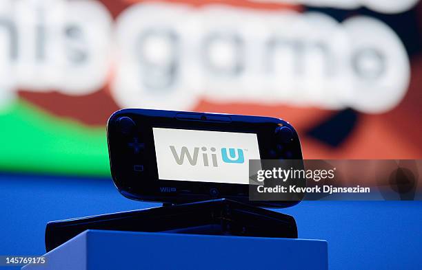 The new Wii U is displayed during a press conference for Nintendo's new hand held game console at the Electronic Entertainment Expo at the Galen...