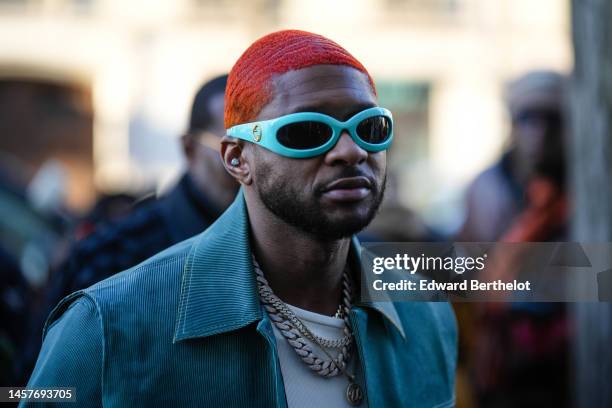 Guest wears blue sunglasses from Gucci, a large silver and diamonds chain necklace, chains necklaces, a white t-shirt, a blue velvet ribbed jacket, a...