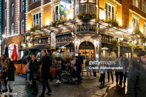 a pub in london - medium group of people stock pictures, royalty-free photos & images