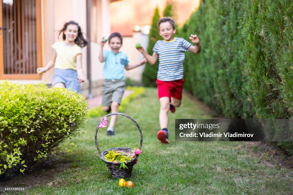 Excited children running towards an Easter basket