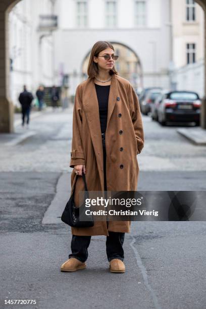 Jacqueline Zelwis wears brown coat Inwear, Uniqlo Shirt, Calvin Klein Jeans, UGG boots Gucci bag, Bottega Veneta sunglasses during the Berlin Fashion...