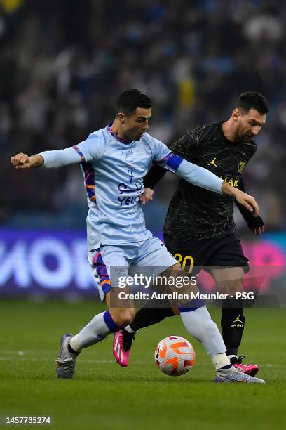 Leo Messi of Paris Saint-Germain and Cristiano Ronaldo of Ruyadh XI fight for possession during the friendly match between Paris Saint-Germain and...