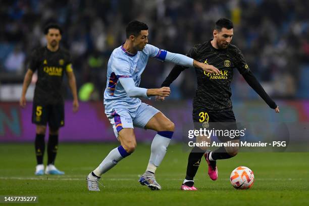 Leo Messi of Paris Saint-Germain and Cristiano Ronaldo of Ruyadh XI fight for possession during the friendly match between Paris Saint-Germain and...