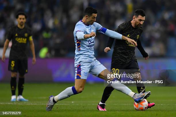 Leo Messi of Paris Saint-Germain and Cristiano Ronaldo of Ruyadh XI fight for possession during the friendly match between Paris Saint-Germain and...