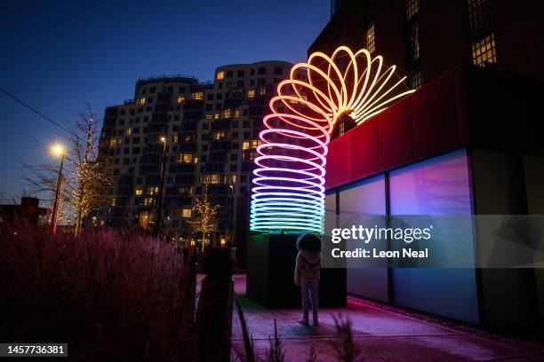 Naya, aged 7, stops to look at "End Over End" by Studio Vertigo at Battersea Power Station on January 19, 2023 in London, England. The Light Festival...