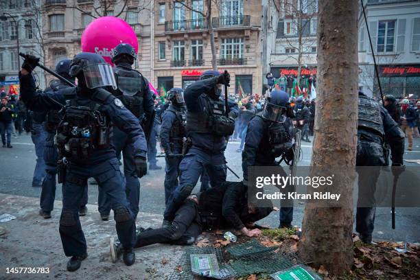 French Riot Police detain a protestor as demonstrations turn violent as over 400,000 people take to the streets of Paris to demonstrate during a...