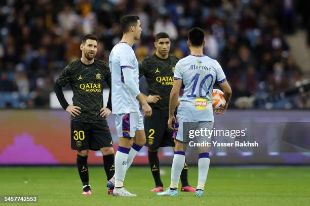 Lionel Messi of Paris Saint-Germain looks towards Cristiano Ronaldo of Riyadh XI during the Winter Tour 2023 friendly between Paris Saint-Germain and...