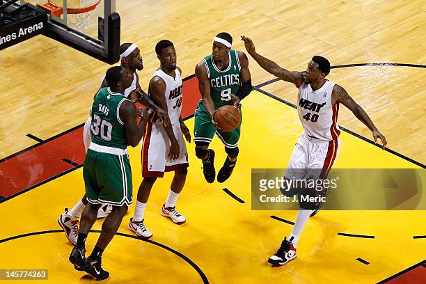 Rajon Rondo of the Boston Celtics drives for a shot attempt against LeBron James, Norris Cole and Udonis Haslem of the Miami Heat in the first half...