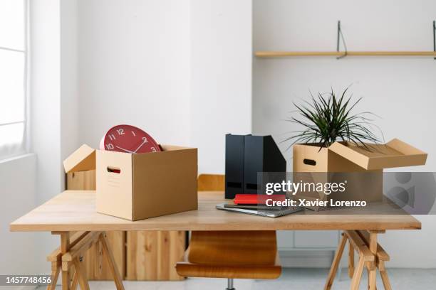 empty new office room with furniture and moving boxes. new business concept with modern desk with professional businessperson belongings on bright co-working workplace. start and beginning concept - being fired stock pictures, royalty-free photos & images