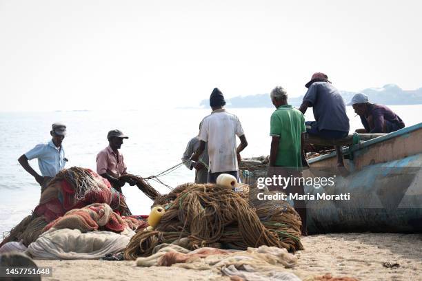 Fishermen pull fish nets on the beach on January 03, 2023 in Galle, Sri Lanka. Galle is the provincial capital and largest city of Southern Province,...