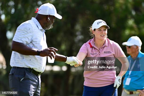 Ally Ewing of the United States fist bumps Emmitt Smith after playing her shot from the ninth tee during the first round of the Hilton Grand...