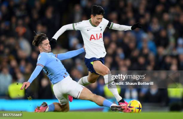 Son Heung-Min of Tottenham Hotspur is tackled by Jack Grealish of Manchester City during the Premier League match between Manchester City and...