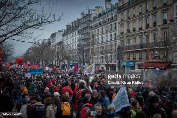 Demonstrators march through central Paris as over 400,000 people take the streets of the French capital to demonstrate against President Macron's...
