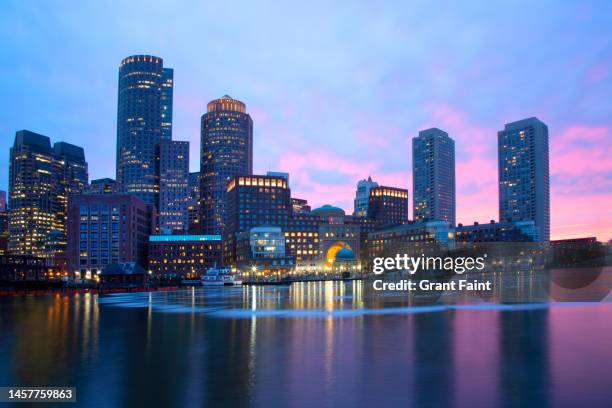 view of city at night - boston harbor stock-fotos und bilder