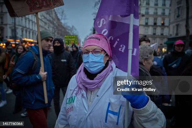 Hospital workers march through central Paris as over 400,000 people take the streets of the French capital to demonstrate against President Macron's...