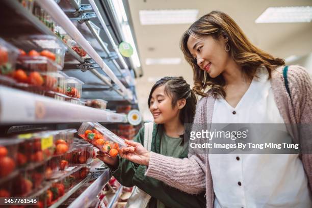 mom & daughter doing grocery shopping for fresh vegetable in supermarket - strawberries stock pictures, royalty-free photos & images