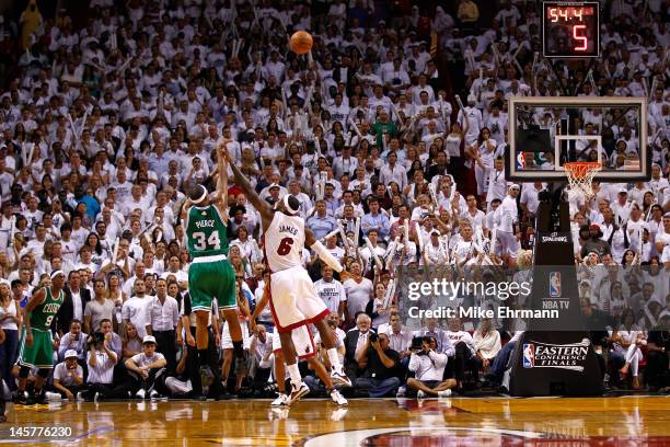Paul Pierce of the Boston Celtics makes a 3-point basket in the final minute of the fourth quarter against LeBron James of the Miami Heat in Game...
