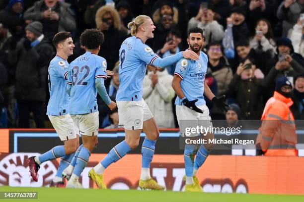 Riyad Mahrez of Manchester City celebrates with team mates after scoring their sides third goal during the Premier League match between Manchester...