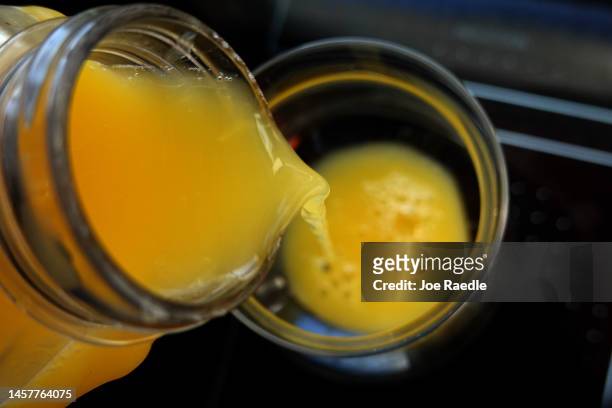 In this photo illustration, orange juice is poured into a glass on January 19, 2023 in Miami, Florida. Orange juice has become expensive as Florida...