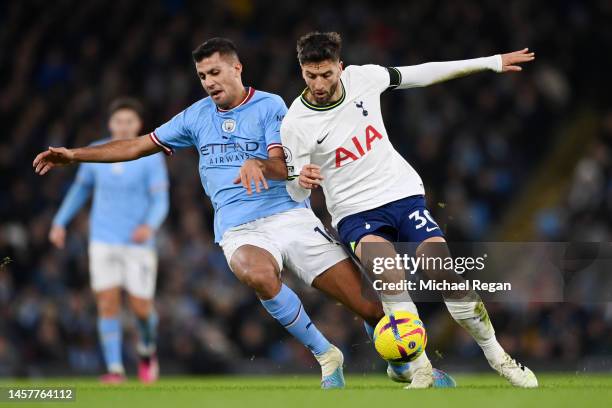 Rodrigo Bentancur of Tottenham Hotspur is challenged by Rodri of Manchester City during the Premier League match between Manchester City and...