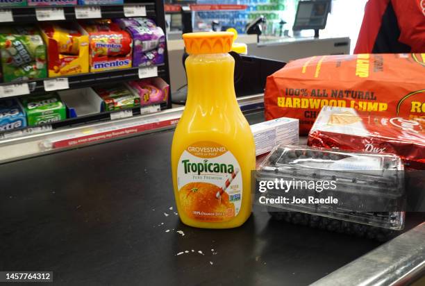 In this photo illustration, a bottle of orange juice sits at the checkout counter of a grocery store on January 19, 2023 in Miami, Florida. Orange...