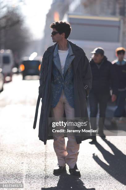 Marc Forne seen wearing a dark trenchcoat, a denim jacket, a white shirt, black sunglasses and beige pants before the Bluemarble show on January 18,...