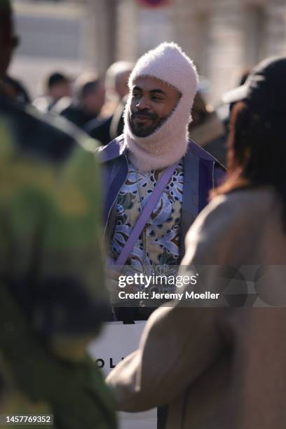 Fashion week guest seen wearing a pink, fluffy balaclava, a paisley patterned shirt and purple jacket before the Bluemarble show during Paris Fashion...