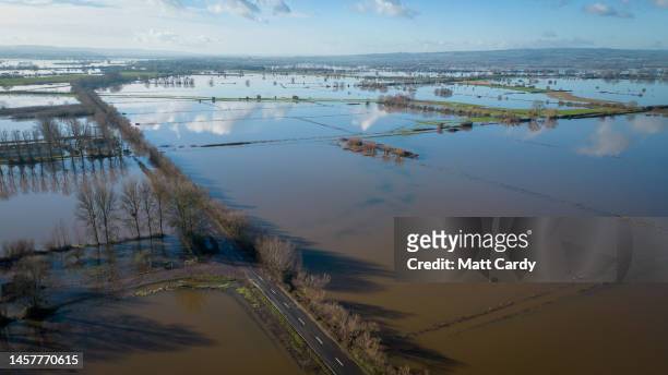 Flood water surrounds the A361 road which has been closed to vehicles because of widespread flooding of the Somerset Levels on January 15, 2023 in...