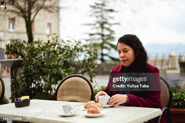 woman resting after work in outdoor cafe in winter. - sidewalk cafe stock pictures, royalty-free photos & images