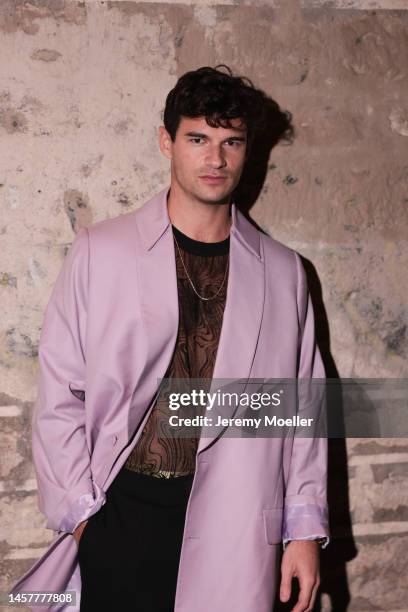 Paul Forman is seen before the Louis-Gabriel Nouchi show wearing a pink long coat, brown and black shirt, black pants and a silver chain during Paris...