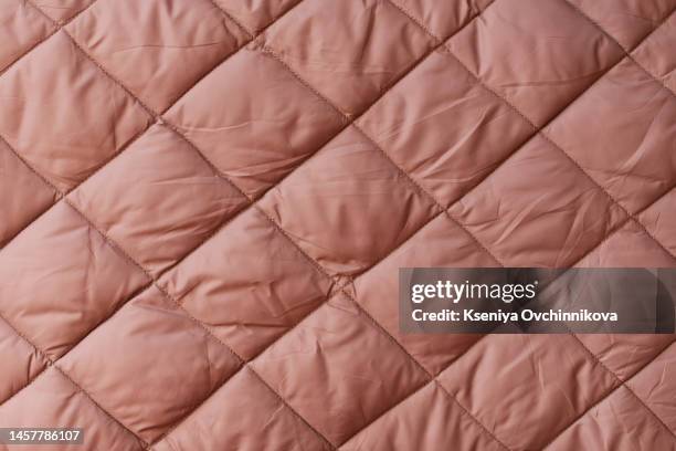 quilted fabric background. beige texture blanket or puffer jacket - bettdecke stock-fotos und bilder