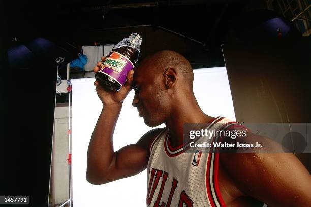 Michael Jordan of the Chicago Bulls cools down with a bottle of Gatorade in 1990 after a game in Chicago, Illinois. NOTE TO USER: User expressly...