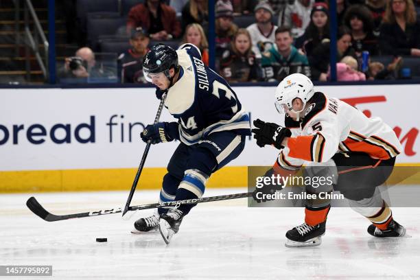 Cole Sillinger of the Columbus Blue Jackets and Urho Vaakanainen of the Anaheim Ducks compete for the puck during the second period at Nationwide...