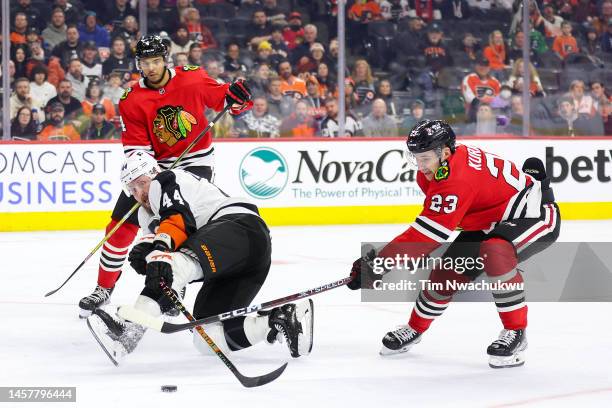 Philipp Kurashev of the Chicago Blackhawks blocks the puck from Nicolas Deslauriers of the Philadelphia Flyers during the second period at Wells...