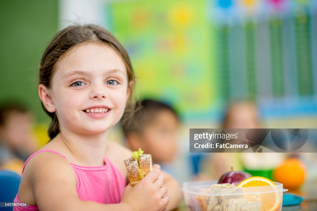 Girl Eating her School Lunch
