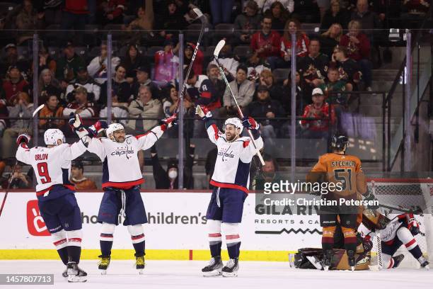 Dmitry Orlov, Alex Ovechkin and Tom Wilson of the Washington Capitals celebrate after Wilson scored a power-play goal against the Arizona Coyotes...