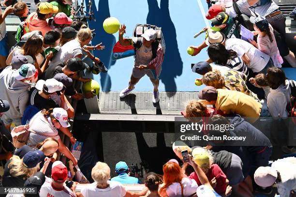 Iga Swiatek of Poland signs autographs for fans after winning the third round singles match against Cristina Bucsa of Spain during day five of the...