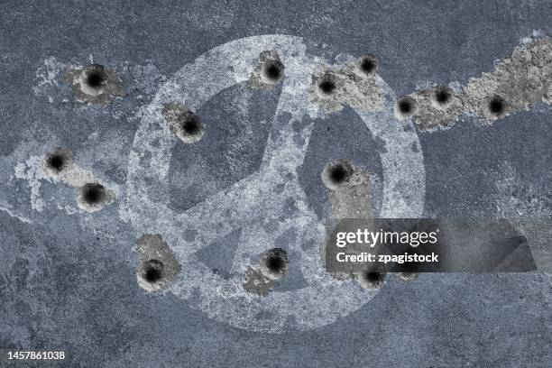 peace symbol on a wall with bullet holes - peace symbol stock pictures, royalty-free photos & images