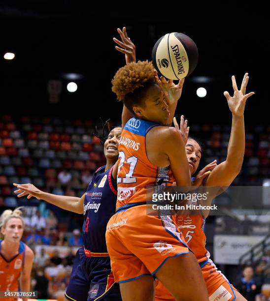Tianna Hawkins and Zitina Aokuso of the Fire contests the ball with with Jacinta Monroe of the Lightning during the round 11 WNBL match between the...