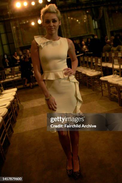 Miley Cyrus attends Marchesa's fall 2013 runway show in Celeste Bartos Forum at the New York Public Library.