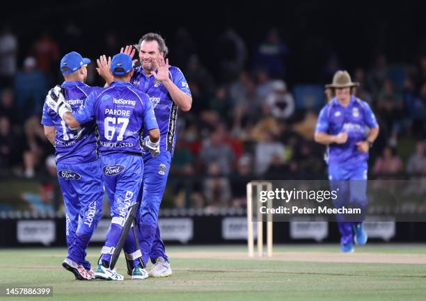 Kyle Mills of Team Cricket celebrates the wicket of Kieran Read with teammates Nathan McCullum and Adam Parore during the T20 Black Clash at Hagley...